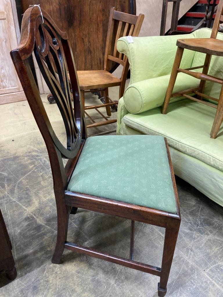 A set of eight George III mahogany shield back dining chairs (two with arms)